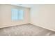 Comfortable bedroom featuring plush carpeting and a bright window, offering a relaxing living space at 10748 Wild Poppy Ave, Las Vegas, NV 89129