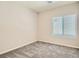 Cozy bedroom featuring plush carpeting and a well-lit window, creating a comfortable retreat at 10748 Wild Poppy Ave, Las Vegas, NV 89129