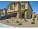 Two-story home featuring a red two-car garage and desert landscaping at 10748 Wild Poppy Ave, Las Vegas, NV 89129