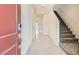 Light-filled foyer with tile flooring and a carpeted staircase at 10748 Wild Poppy Ave, Las Vegas, NV 89129