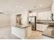 Open concept living room with access to the kitchen featuring stainless steel appliances at 10748 Wild Poppy Ave, Las Vegas, NV 89129