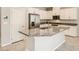 Stylish kitchen featuring a center island with granite countertop, stainless steel appliances, and white cabinets at 10748 Wild Poppy Ave, Las Vegas, NV 89129