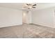 Vast living room featuring neutral walls, plush carpet, and ceiling fan, ideal for relaxation and entertainment at 10748 Wild Poppy Ave, Las Vegas, NV 89129