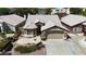 Aerial shot showcases a well-maintained home with stone accents, landscaping, and driveway at 1713 Diamond Oaks Ct, Las Vegas, NV 89117