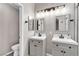 Bathroom with double vanity sinks, stylish fixtures, and modern toilet; a serene space at 1713 Diamond Oaks Ct, Las Vegas, NV 89117