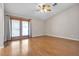 Spacious bedroom features wood-look floors, vaulted ceiling, and glass doors to the outside at 1713 Diamond Oaks Ct, Las Vegas, NV 89117