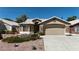 Charming single-story home boasts stone accents, a well-manicured yard, and a two-car garage at 1713 Diamond Oaks Ct, Las Vegas, NV 89117