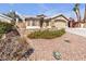 Charming home featuring a stone facade, two-car garage, and drought resistant landscaping at 1713 Diamond Oaks Ct, Las Vegas, NV 89117