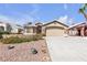 Charming home featuring a stone facade, two-car garage, and drought resistant landscaping at 1713 Diamond Oaks Ct, Las Vegas, NV 89117
