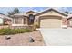 Charming home featuring a stone facade, two-car garage, and drought resistant landscaping at 1713 Diamond Oaks Ct, Las Vegas, NV 89117
