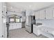 Bright kitchen featuring white cabinetry, stainless steel appliances, and tile floors at 1713 Diamond Oaks Ct, Las Vegas, NV 89117