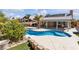 This home features a sparkling blue swimming pool, a covered patio and desert landscaping at 1713 Diamond Oaks Ct, Las Vegas, NV 89117
