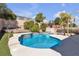 A refreshing swimming pool surrounded by desert landscaping creates an inviting outdoor retreat at 1713 Diamond Oaks Ct, Las Vegas, NV 89117