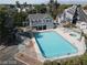 Aerial view of a community pool surrounded by lush trees and residential buildings, perfect for relaxing at 1912 Nebula Dr, Las Vegas, NV 89115