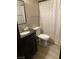 Bathroom features a modern sink, vanity, toilet, mirror, and shower with patterned curtain at 1912 Nebula Dr, Las Vegas, NV 89115