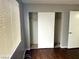 Bedroom with closet and dark wood-look floors, bathed in natural light at 1912 Nebula Dr, Las Vegas, NV 89115