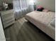 Comfortable bedroom with soft lighting, a dresser, and window to create a restful ambiance at 1912 Nebula Dr, Las Vegas, NV 89115