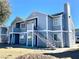 Two-story apartments featuring stairways leading to the upper floors under a clear, bright blue sky at 1912 Nebula Dr, Las Vegas, NV 89115