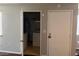 Small laundry closet with stacked washer and dryer and shelving for storage at 1912 Nebula Dr, Las Vegas, NV 89115