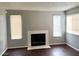 Cozy living room with hardwood floors, a fireplace, and natural light streaming through the windows at 1912 Nebula Dr, Las Vegas, NV 89115