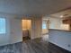 Open-concept living space featuring wood-look flooring, adjacent to an interior laundry closet at 1912 Nebula Dr, Las Vegas, NV 89115