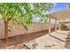 Image of covered patio area with a block wall and landscaping in the background at 202 Twin Creek St, Henderson, NV 89074