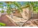 View of back patio and side of home, surrounded by mature trees at 202 Twin Creek St, Henderson, NV 89074
