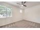 Light, bright bedroom with neutral carpet, ceiling fan, and a large picture window at 202 Twin Creek St, Henderson, NV 89074