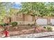 Charming single-story house with well-maintained landscaping, including desert rock and mature trees at 202 Twin Creek St, Henderson, NV 89074