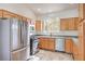 Well-lit kitchen features stainless steel appliances, light wood cabinets, and a garden view window at 202 Twin Creek St, Henderson, NV 89074