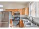 Well lit kitchen featuring stainless steel appliances and light wood cabinets at 202 Twin Creek St, Henderson, NV 89074
