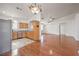 Open-concept living area and kitchen with hardwood floors, stainless steel appliances, and neutral paint at 202 Twin Creek St, Henderson, NV 89074