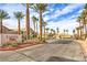 Rainbow Villas community entrance with desert landscaping, palm trees, and well-maintained homes at 202 Twin Creek St, Henderson, NV 89074