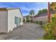 This charming backyard features low-maintenance desert landscaping, including a brick wall, palm trees, and tasteful greenery at 2229 Suffron Hills Ct, Henderson, NV 89044