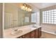 Bright bathroom with a double sink vanity, large mirror, separate shower, and tub at 2229 Suffron Hills Ct, Henderson, NV 89044