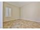 A vacant bedroom featuring tile flooring and a window with shutter-style blinds at 2229 Suffron Hills Ct, Henderson, NV 89044