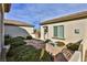 Exterior courtyard with mature landscaping and a charming stone bench at 2229 Suffron Hills Ct, Henderson, NV 89044