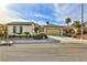 Charming single-story home featuring a two-car garage and well-manicured landscaping with palm trees at 2229 Suffron Hills Ct, Henderson, NV 89044