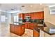 Gourmet kitchen with dark wood cabinets, granite countertops, and stainless steel appliances for modern cooking at 2229 Suffron Hills Ct, Henderson, NV 89044