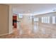 Open-concept living area featuring tile flooring, plantation shutters, and views into the kitchen at 2229 Suffron Hills Ct, Henderson, NV 89044