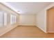 Large, bright living room with wood-look flooring and plantation shutters, offering a versatile living area at 2229 Suffron Hills Ct, Henderson, NV 89044