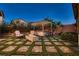 Relax in this backyard with a firepit, pavers and artificial turf at 2664 Ornate Regiment St, Henderson, NV 89044
