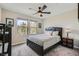 Comfortable bedroom featuring a ceiling fan and a large window providing ample natural light at 2664 Ornate Regiment St, Henderson, NV 89044