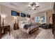 Relaxing bedroom with a tray ceiling, a large bed, and natural lighting at 2664 Ornate Regiment St, Henderson, NV 89044