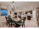Elegant dining area with a chandelier and an open layout to the living room at 2664 Ornate Regiment St, Henderson, NV 89044