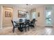 Dining room features modern chandelier, decorative art, and access to outdoor patio at 2664 Ornate Regiment St, Henderson, NV 89044