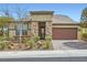 Inviting single-story home with stone accents and a well-maintained desert landscape in the front yard at 2664 Ornate Regiment St, Henderson, NV 89044