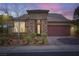 Charming single-story home with a stone facade, well-maintained landscaping, and a two-car garage at 2664 Ornate Regiment St, Henderson, NV 89044