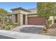 Charming front exterior showcases a two-car garage and meticulously designed desert landscaping at 2664 Ornate Regiment St, Henderson, NV 89044