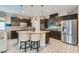 Well-appointed kitchen with stainless steel appliances, granite countertops, and a kitchen island with seating at 2664 Ornate Regiment St, Henderson, NV 89044